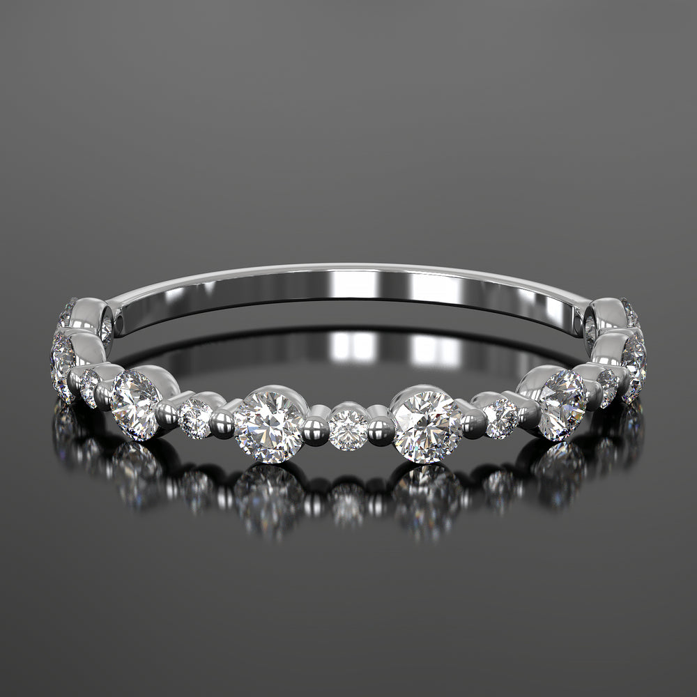 Dainty wedding band with alternating round diamonds in a shared single prong setting, floating design.