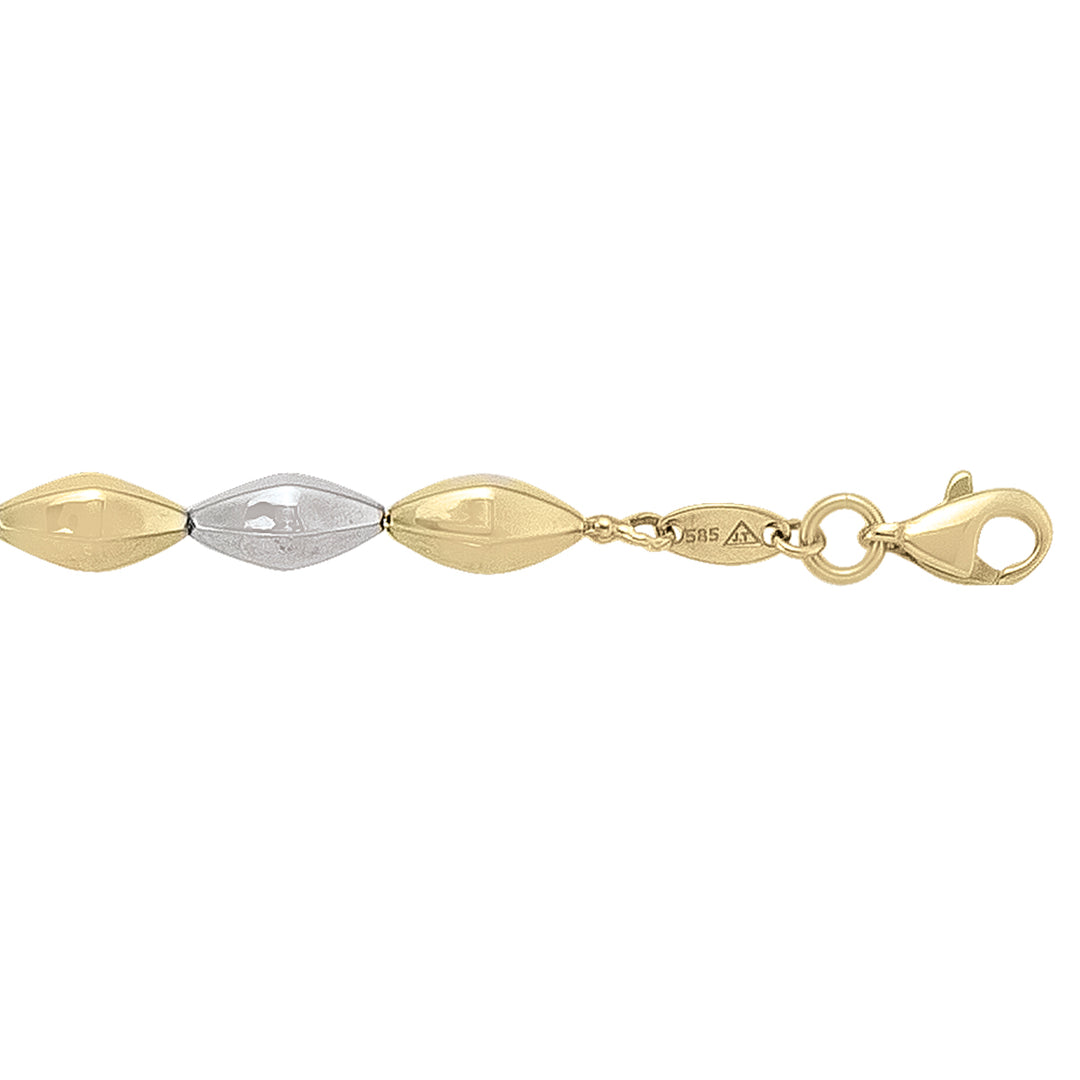 Two-tone 14k yellow and white gold hollow fancy bracelet with marquise-shaped links and lobster clasp.