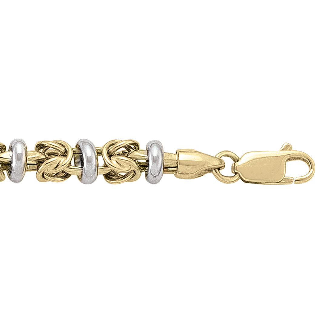 Two-tone 14k yellow and white gold hollow fancy bracelet with interlocking links and lobster clasp.