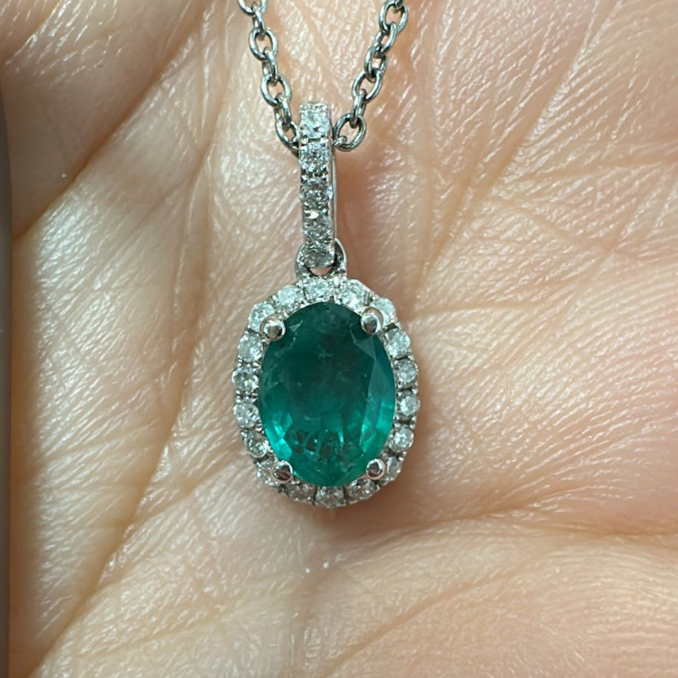 Oval-cut Zambian emerald pendant with diamond halo in 14K white gold.