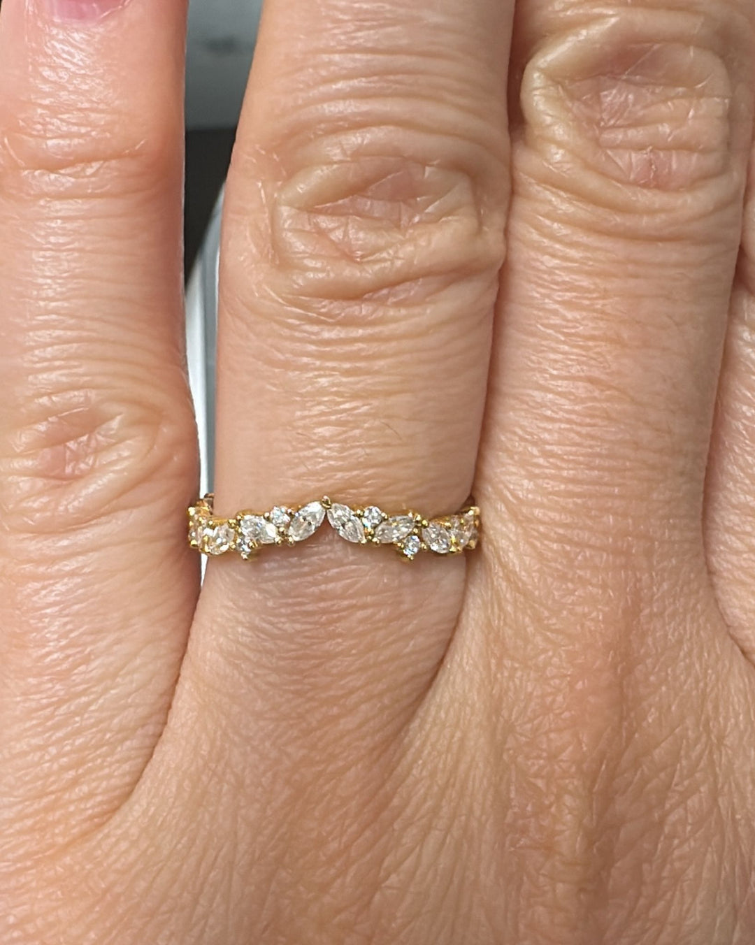 18K yellow gold moissanite band with marquise and round stones in an elegant design.