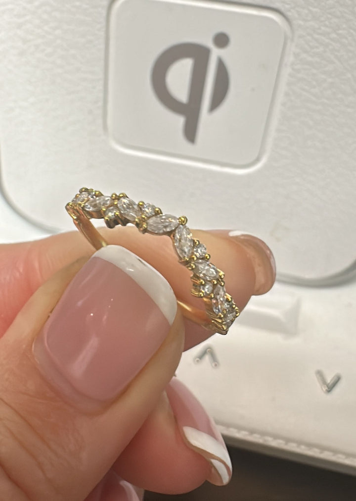 18K yellow gold moissanite band with marquise and round stones in an elegant design.