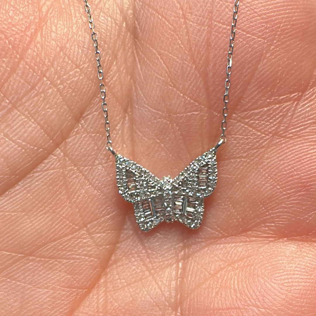 14K white gold butterfly pendant necklace with 0.23 Ct natural round and baguette diamonds.