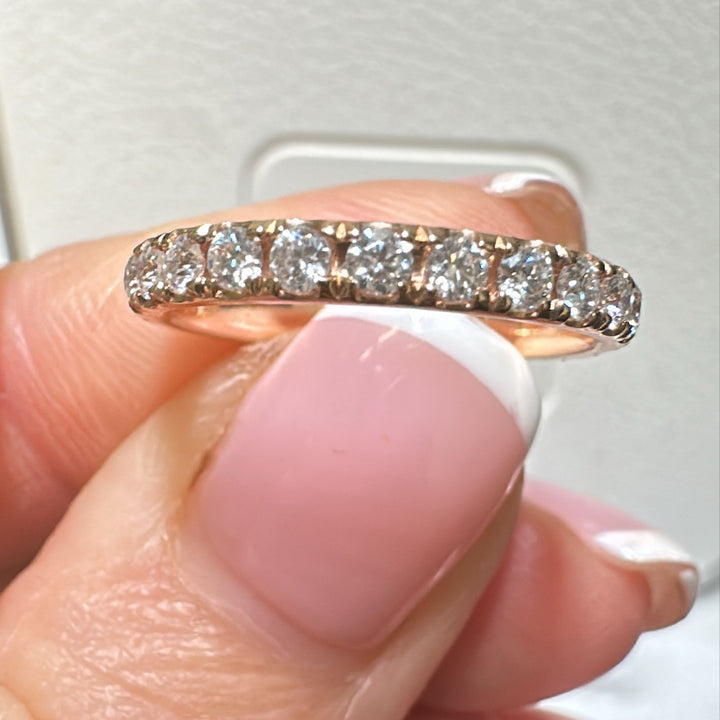 Moissanite eternity wedding band in 14K/18K gold or platinum with round brilliant stones.