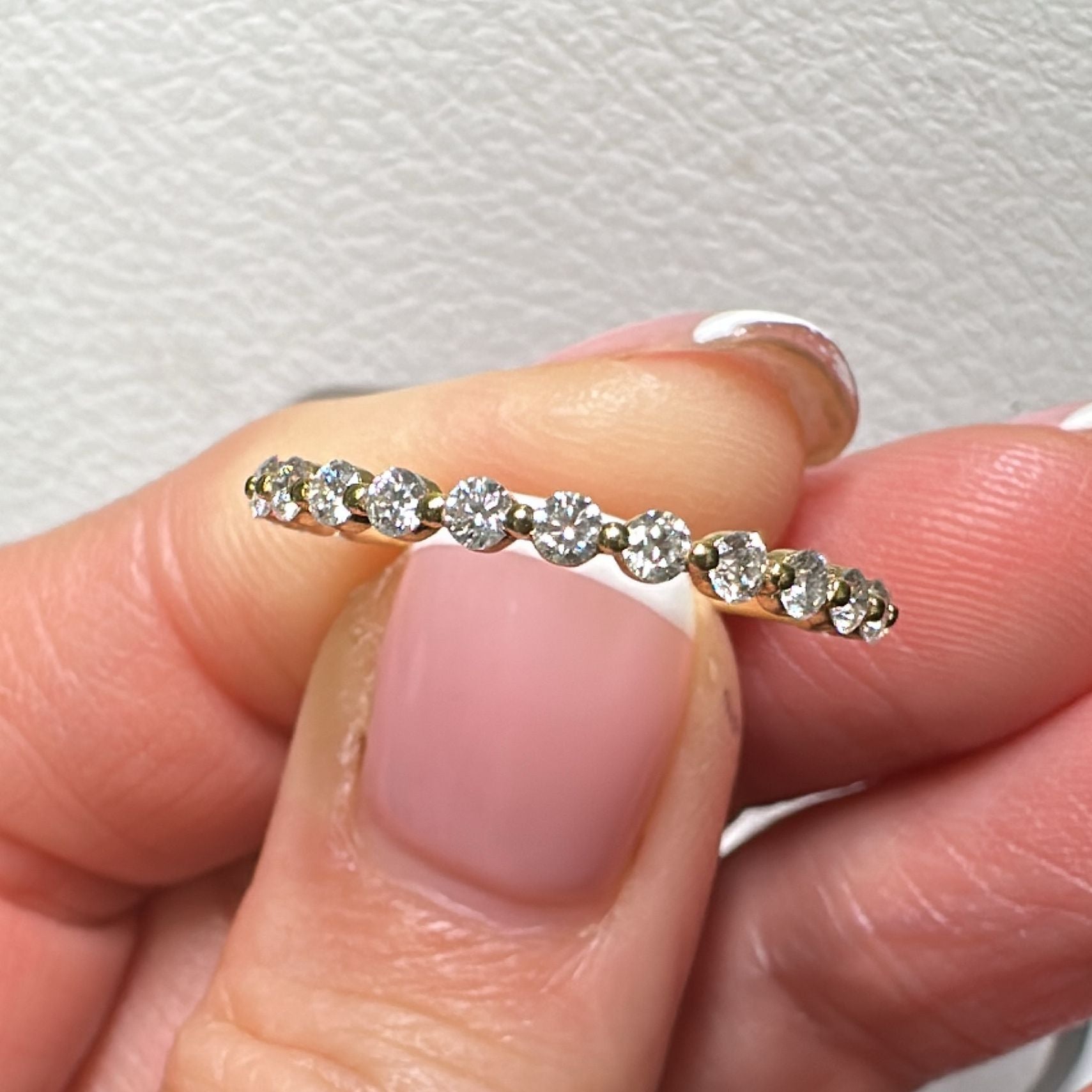 Moissanite eternity wedding ring in 14K/18K gold or platinum with round brilliant stones.