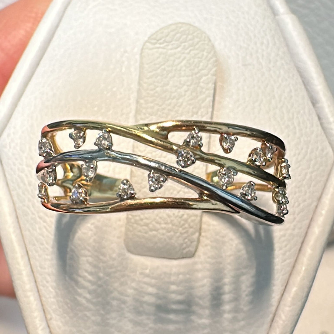 Two-tone gold anniversary ring with 0.13 CT natural diamonds in an openwork design.