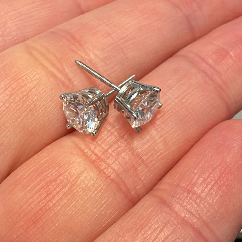 6mm moissanite stud earrings in 14K white gold with a classic 4-prong setting.