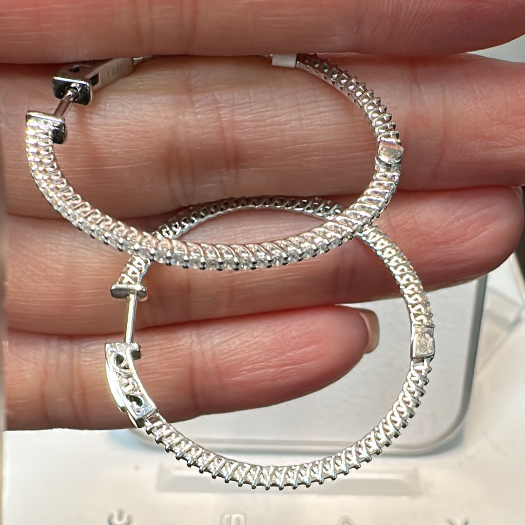 34mm moissanite hoop earrings in 14K white gold with a secure lock closure.