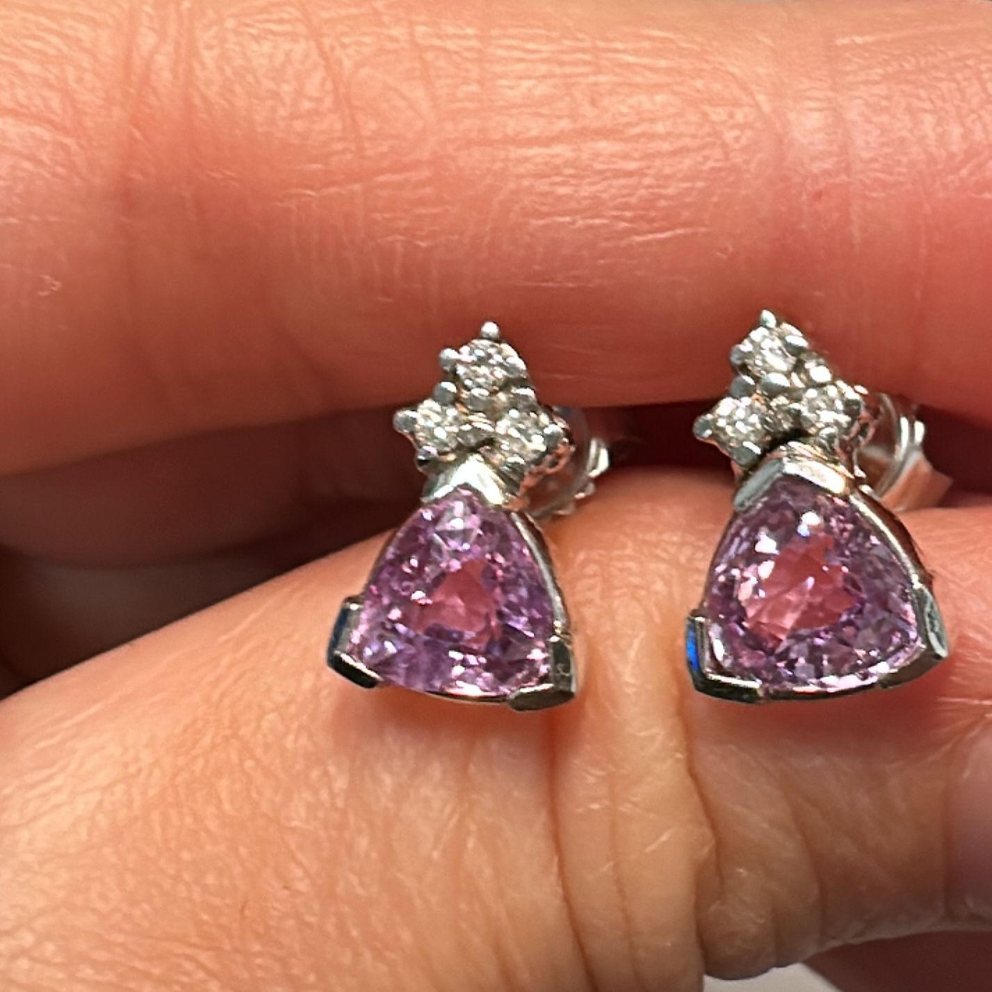 Trillion-cut purple sapphire and diamond stud earrings set in 14K white gold.