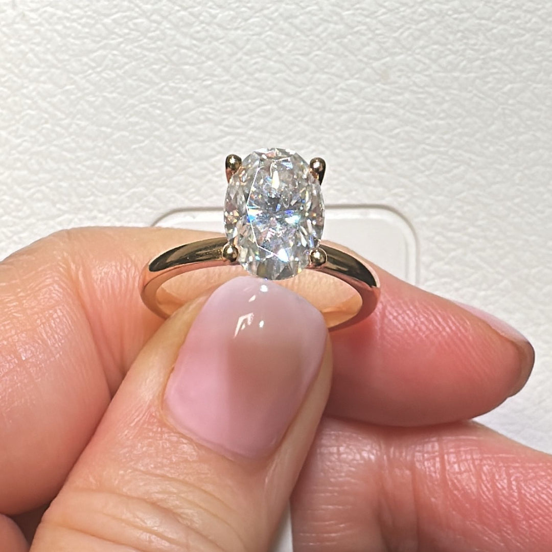 2.2 Ct oval solitaire moissanite engagement ring in 18K gold.