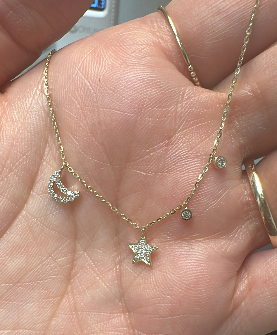 14K yellow gold diamond necklace with moon and star charms and adjustable 16–18" chain