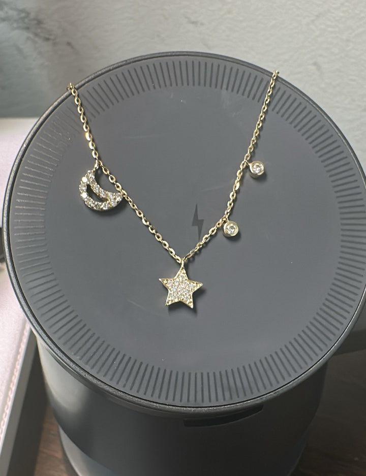 14K yellow gold diamond necklace with moon and star charms and adjustable 16–18" chain