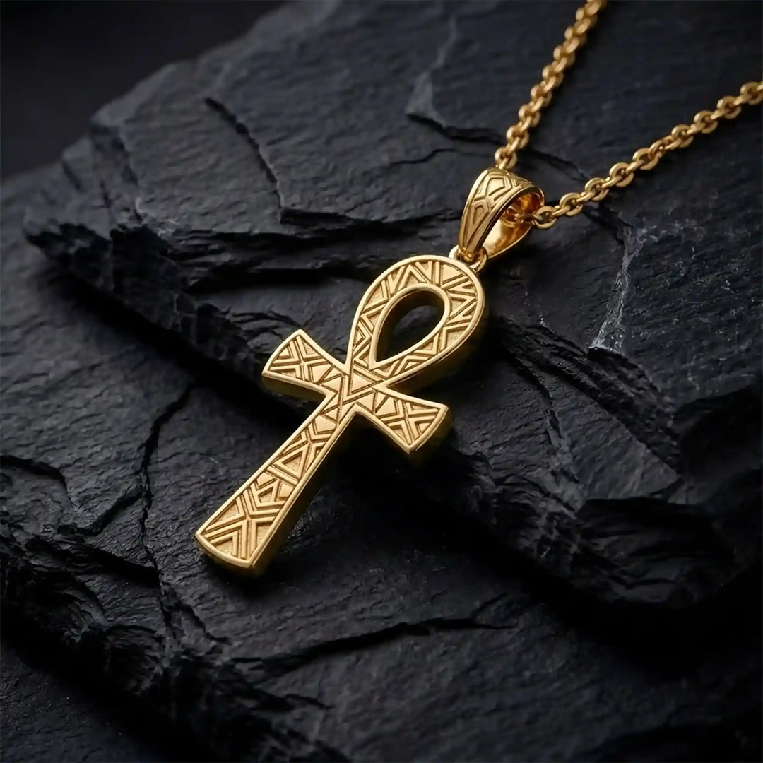 Ankh cross pendant necklace with engraved Egyptian pattern displayed on Black stone.