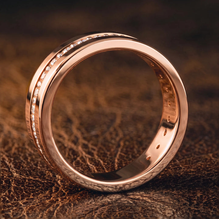 Channel set round lab-grown diamond wedding band with flat beveled profile displayed at an angle.