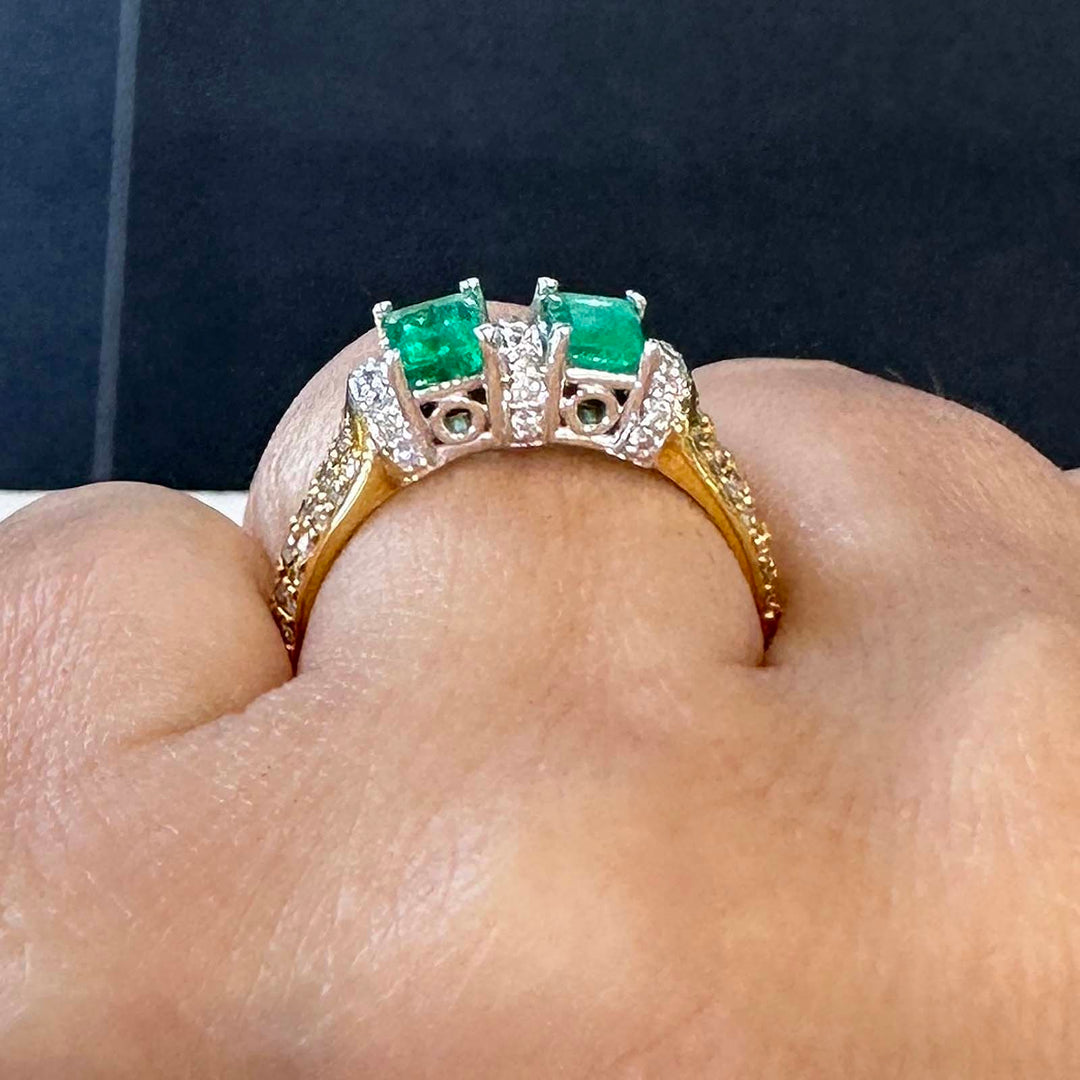 Custom double stone Colombian emerald ring in 18k yellow gold with natural diamonds.