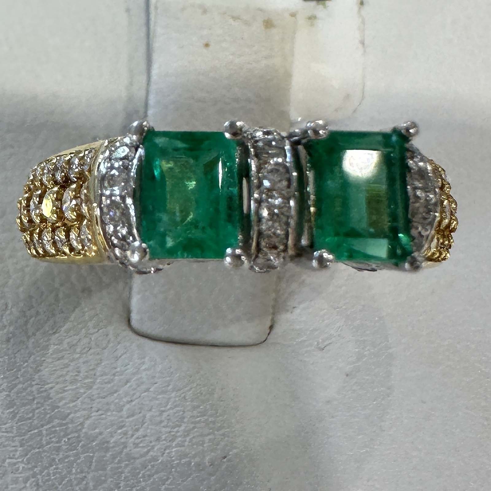 Custom double stone Colombian emerald ring in 18k yellow gold with natural diamonds.