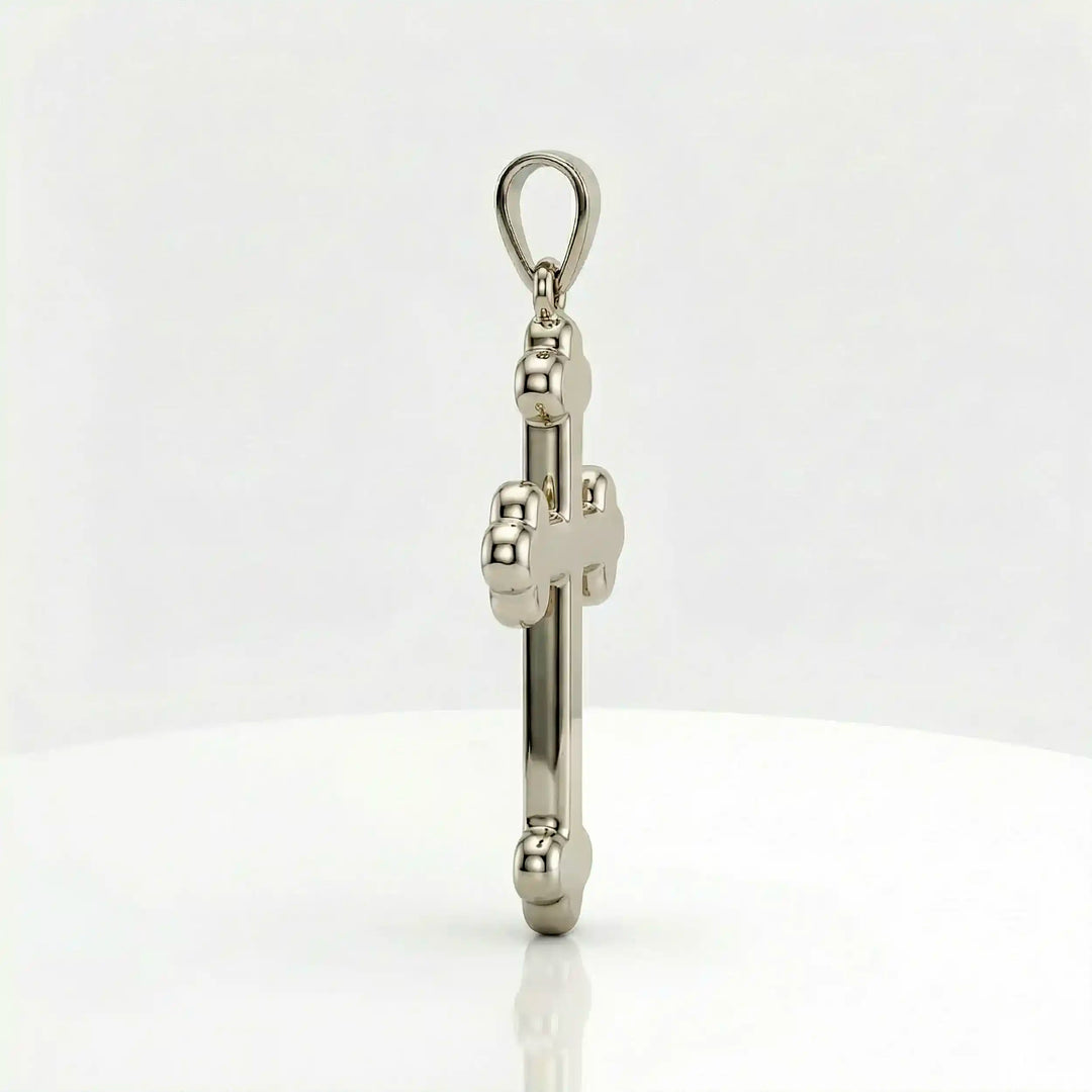 Cross fleury pendant necklace with fleur-shaped cross ends displayed on white background.