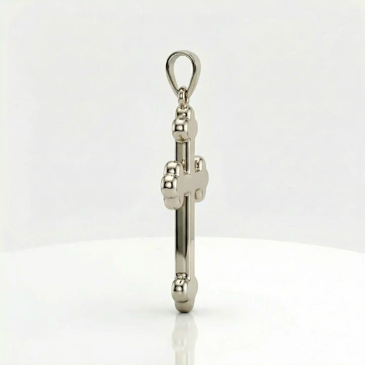 Cross fleury pendant necklace with fleur-shaped cross ends displayed on white background.