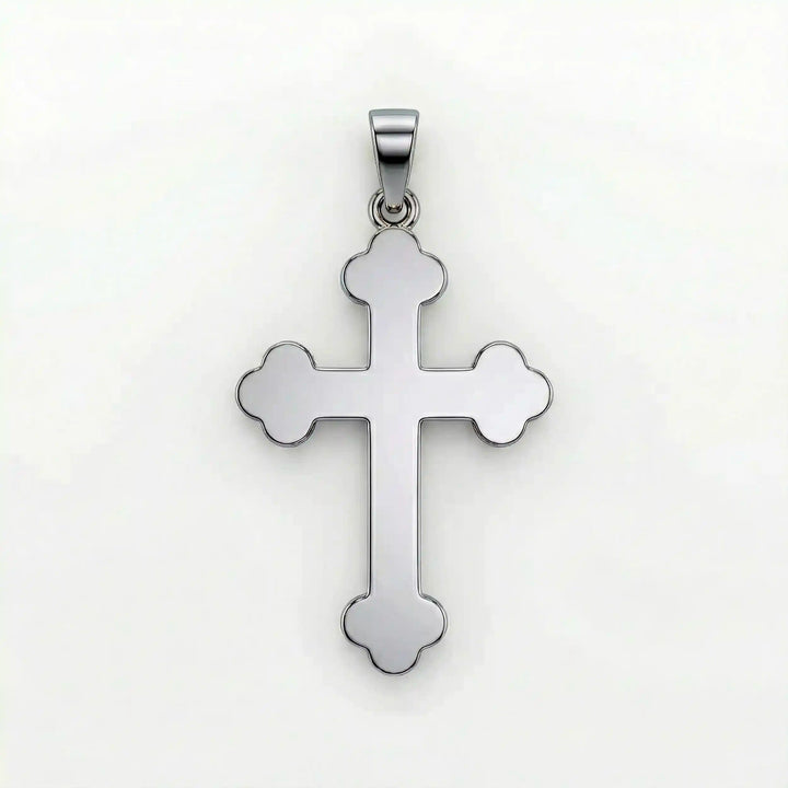 Cross fleury pendant necklace with fleur-shaped cross ends displayed on white background.