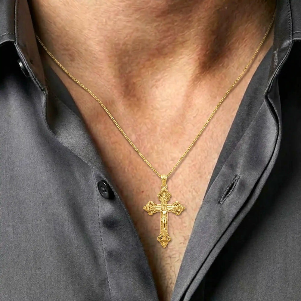 Crucifix cross pendant necklace with detailed Jesus Christ figure displayed on chest.