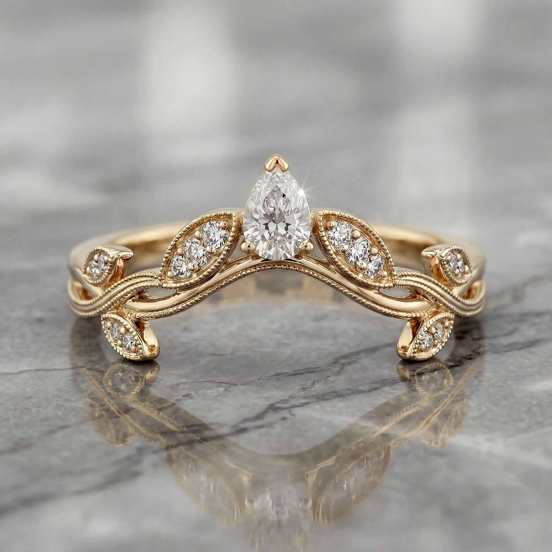 Curved wedding band with marquise and round lab-grown diamonds shown on reflective surface.