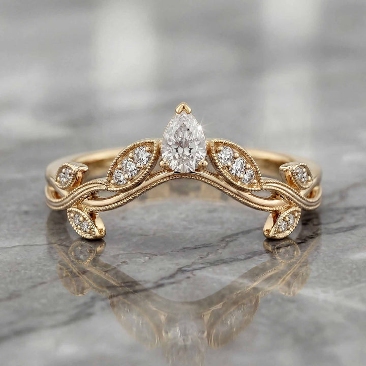 Curved wedding band with marquise and round lab-grown diamonds shown on reflective surface.