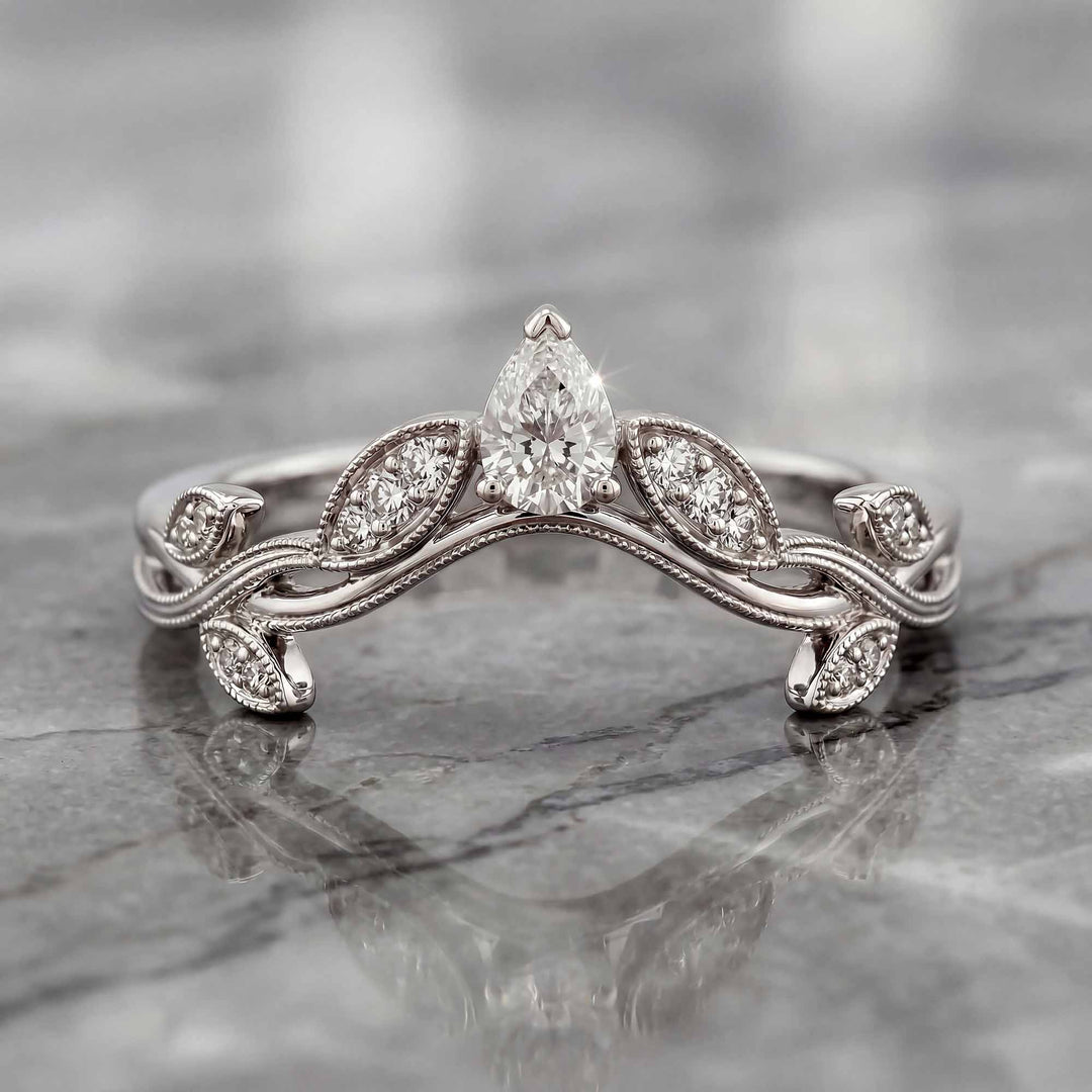 Curved wedding band with marquise and round lab-grown diamonds shown on reflective surface.