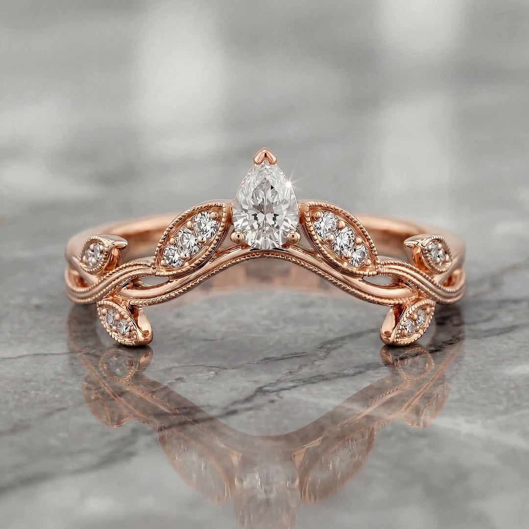 Curved wedding band with marquise and round lab-grown diamonds shown on reflective surface.