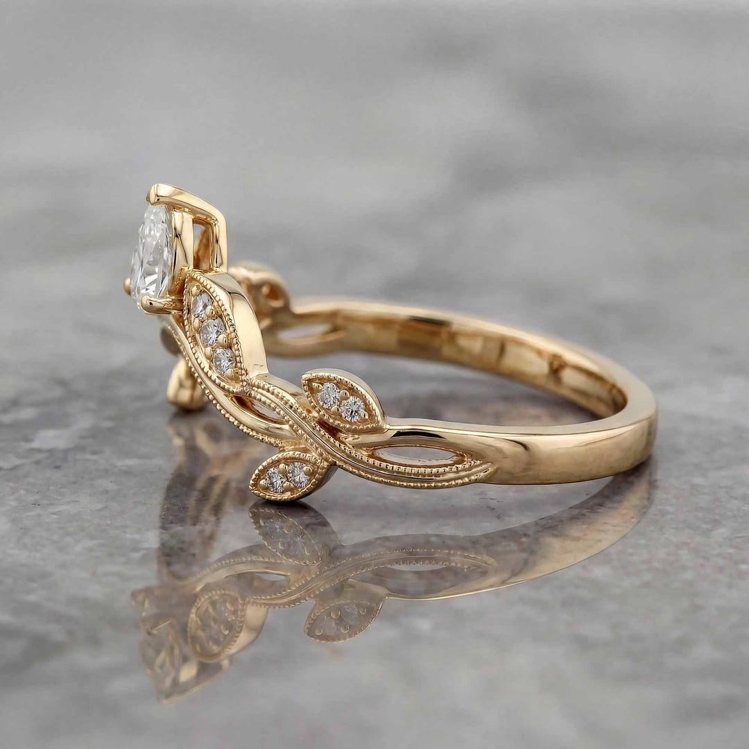 Curved wedding band with marquise and round lab-grown diamonds shown on reflective surface.