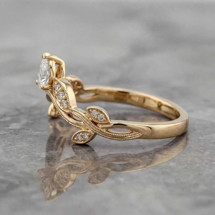 Curved wedding band with marquise and round lab-grown diamonds shown on reflective surface.