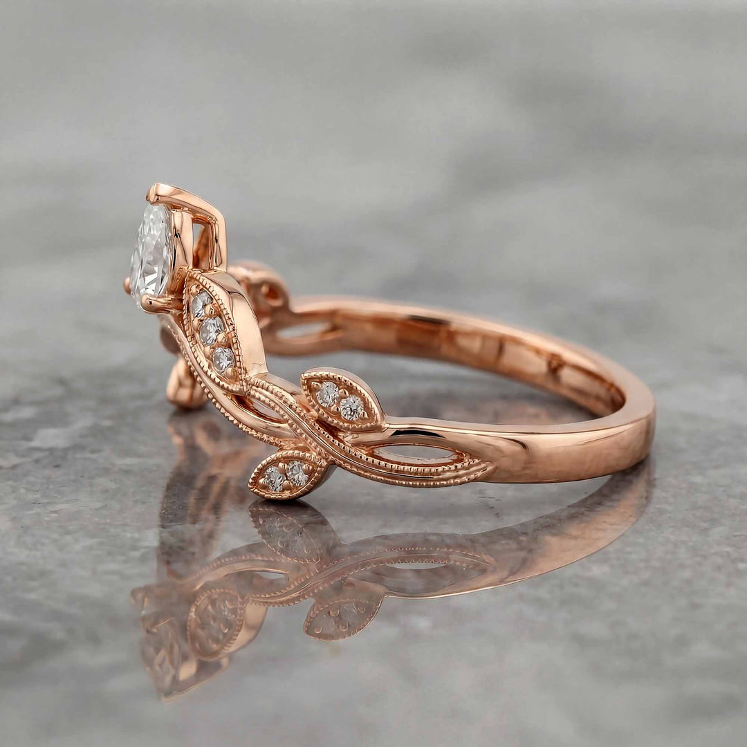 Curved wedding band with marquise and round lab-grown diamonds shown on reflective surface.
