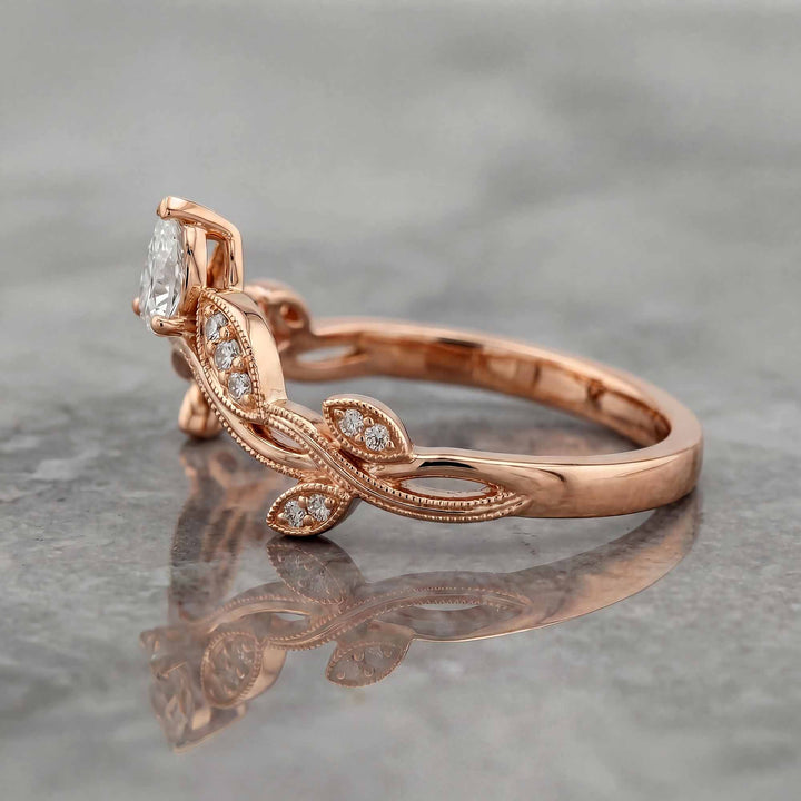 Curved wedding band with marquise and round lab-grown diamonds shown on reflective surface.