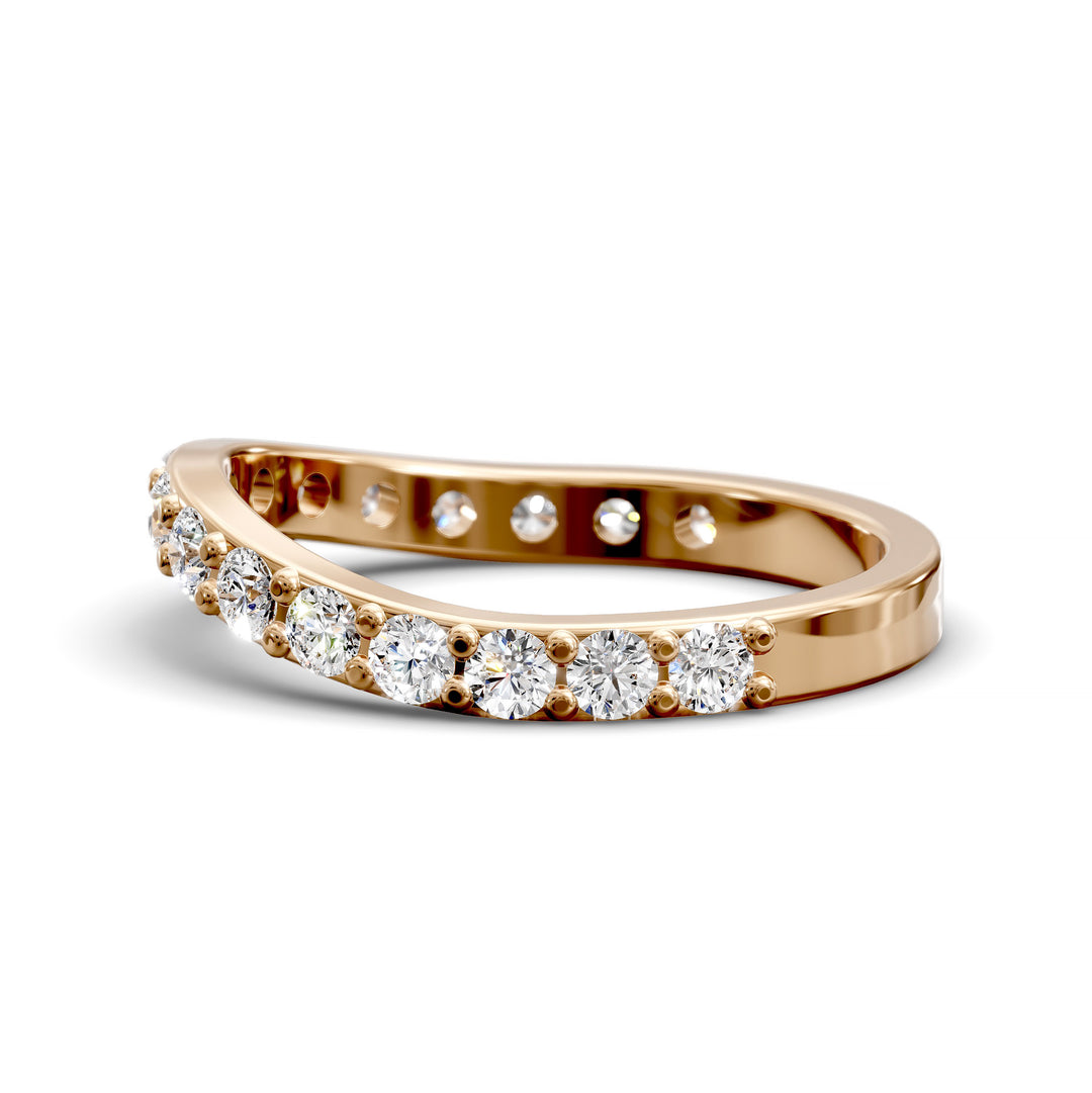 Curved half eternity diamond band with prong set round stones in polished gold