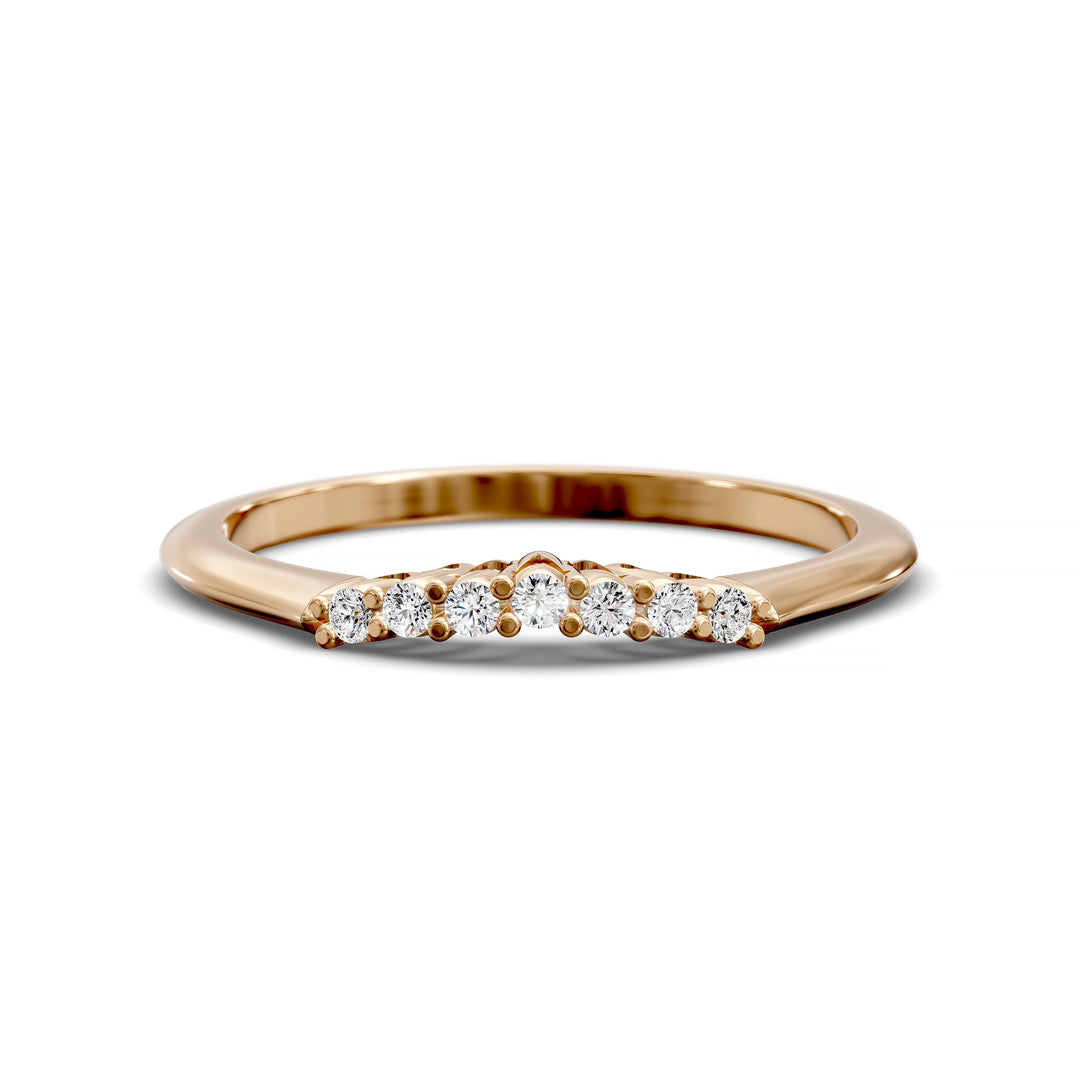 Curved diamond wedding band with shared-prong setting and open gallery, featuring seven round stones