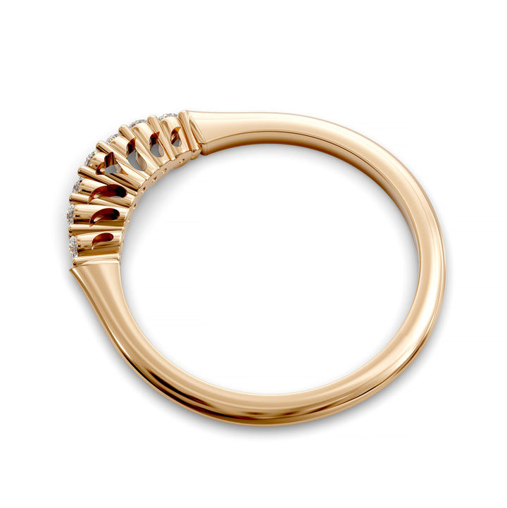 Curved diamond wedding band with shared-prong setting and open gallery, featuring seven round stones