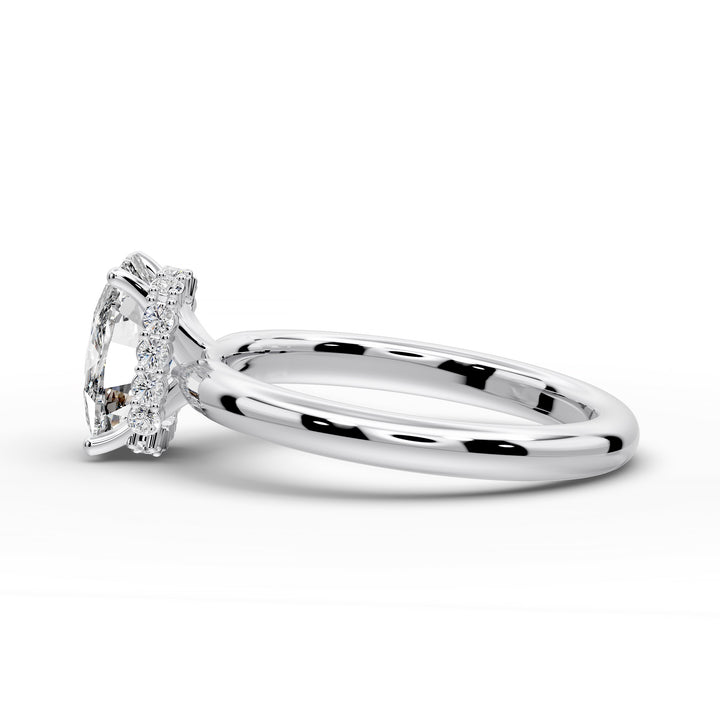 Elongated cushion diamond hidden halo cathedral engagement ring with half-round band shown in studio lighting.