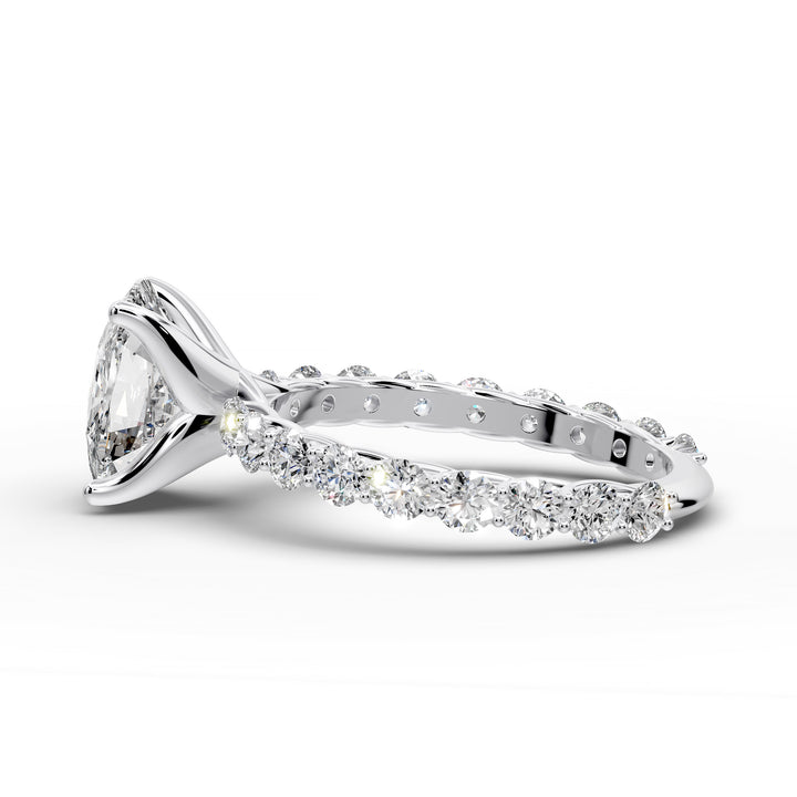 Elongated cushion diamond engagement ring with shared prong band shown in a studio display.