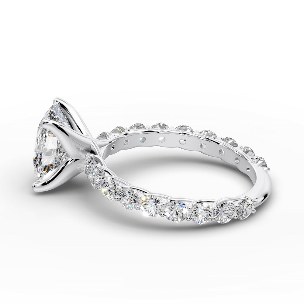 Elongated cushion diamond engagement ring with shared prong band shown in a studio display.
