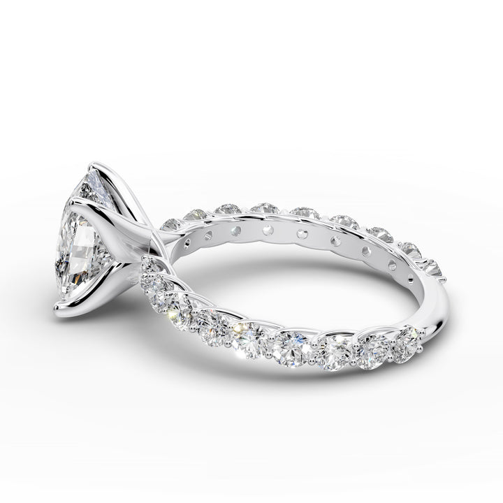 Elongated cushion diamond engagement ring with shared prong band shown in a studio display.
