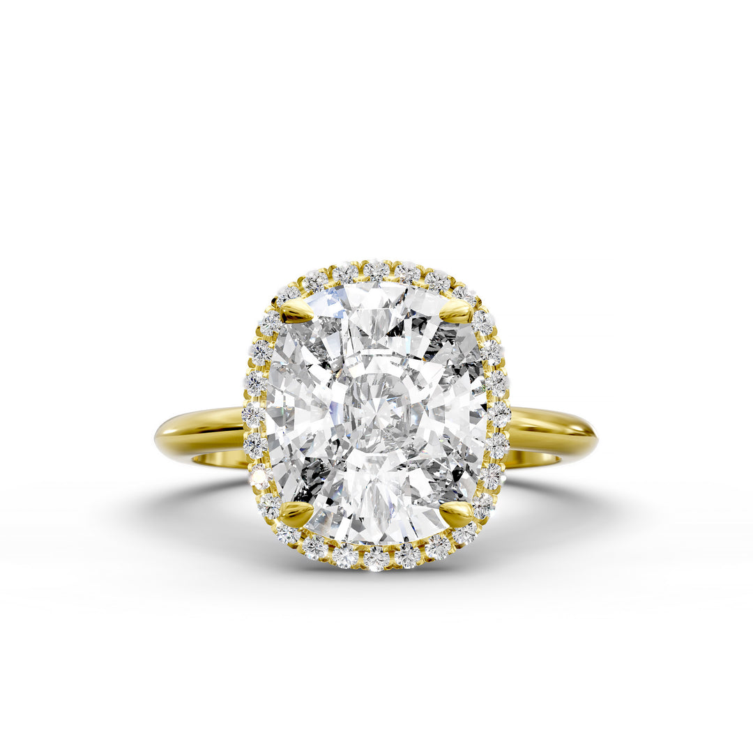 Elongated cushion halo diamond engagement ring with sleek band in studio lighting.