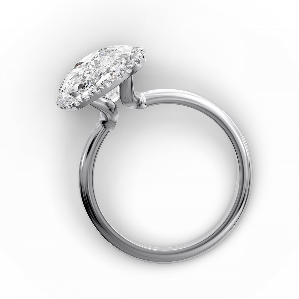 Elongated cushion halo diamond engagement ring with sleek band in studio lighting.