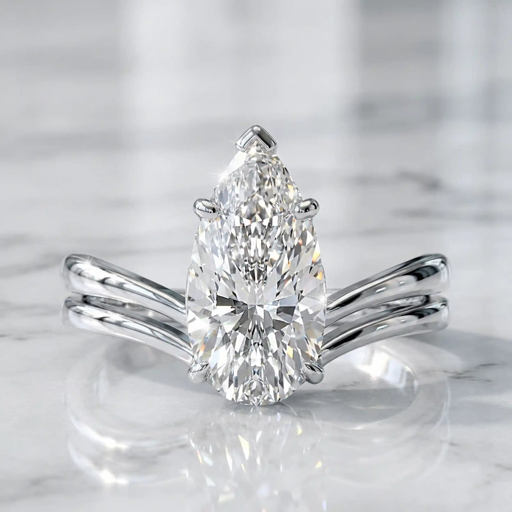 2.5 carat elongated pear lab diamond double band solitaire engagement ring on marbel.
