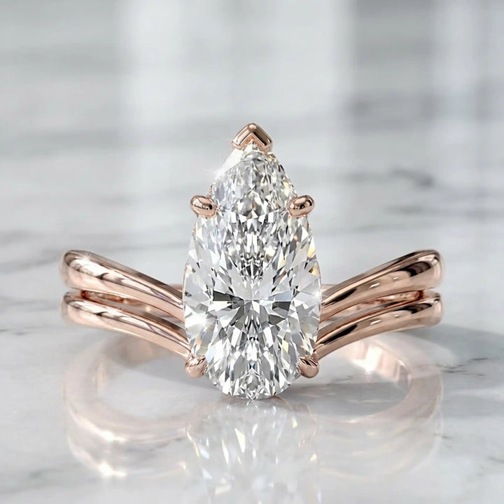 2.5 carat elongated pear lab diamond double band solitaire engagement ring on marbel.
