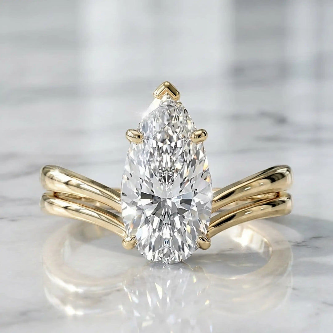2.5 carat elongated pear lab diamond double band solitaire engagement ring on marbel.
