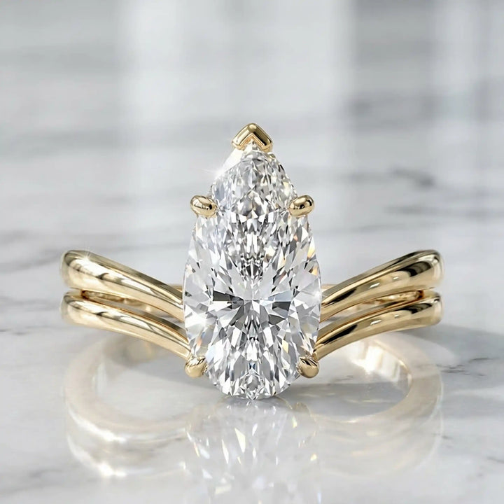 2.5 carat elongated pear lab diamond double band solitaire engagement ring on marbel.
