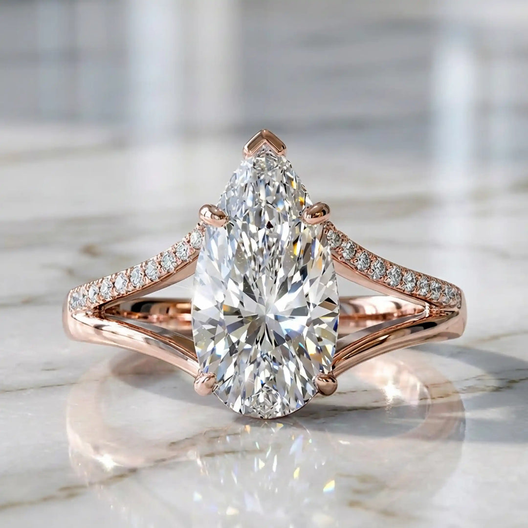 3 carat elongated pear lab diamond split shank engagement ring with pavé band on display.
