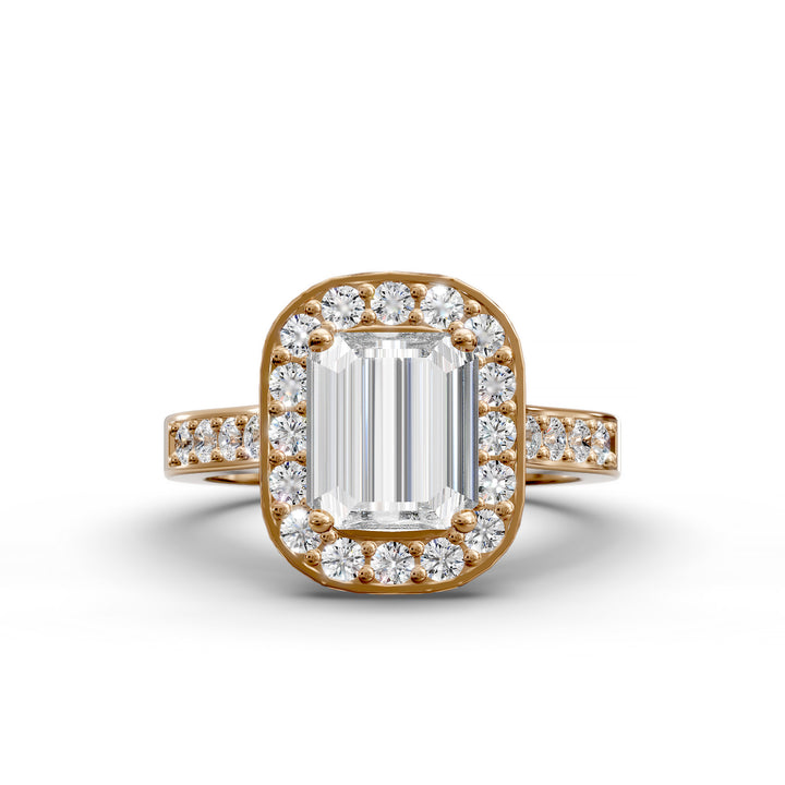 Emerald-cut diamond halo engagement ring with channel-set diamond band shown in studio lighting.