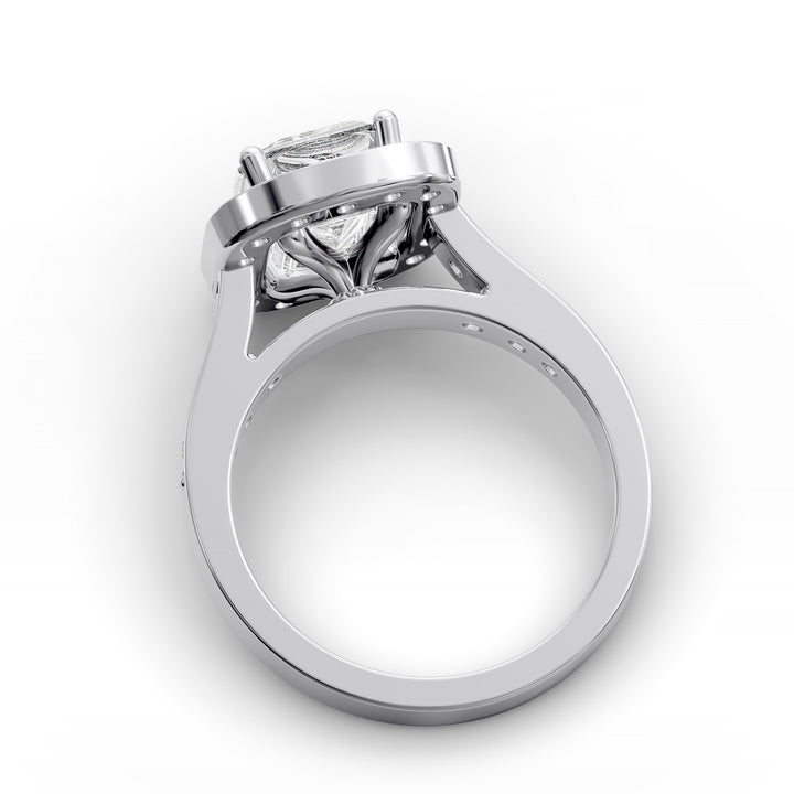 Emerald-cut diamond halo engagement ring with channel-set diamond band shown in studio lighting.