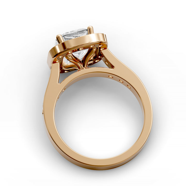 Emerald-cut diamond halo engagement ring with channel-set diamond band shown in studio lighting.