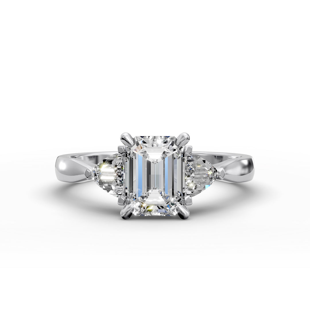emerald-cut three-stone engagement ring with trapezoid side diamonds and tapered band shown from multiple angles